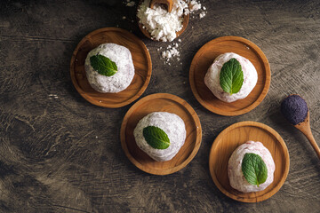 Japanese mochi or rice cake filled with red bean and strawberry, mint leaves on top. Japan traditional rice cake.