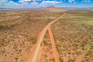 Looking down at intersecting dirt tracks at the red terrain earth in outback Australia
