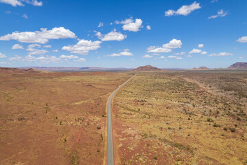 Aerial view of remote asphalt road that curves in the distance in the Australian outback