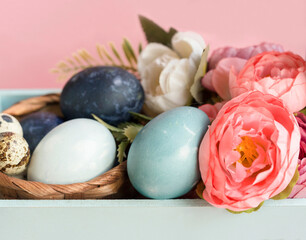 .Colorful Easter eggs are beautifully stacked in a box on a pink background. Concept . decorations for Easter. Close-up. Selective focus