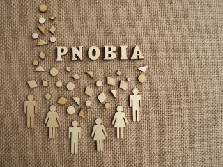 mental illness-phobia in the form of wooden letters and figures of people on a jute background