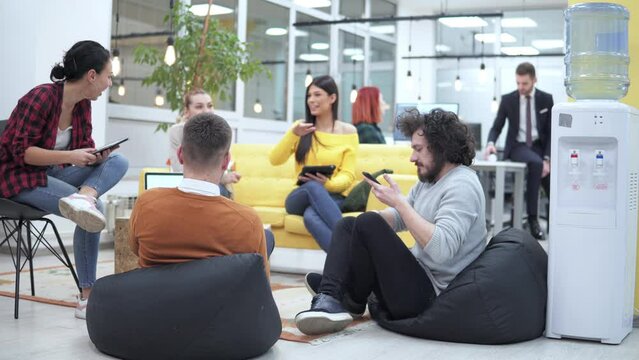 Business people having casual discussion during meeting in startup developer company office