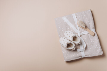 Newborn background. Baby muslin with bow, shoes, wooden brush, bib, eco teether, organic cotton...