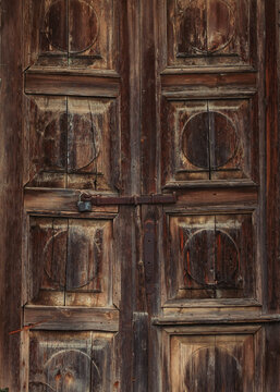 Old shabby wooden door with a padlock