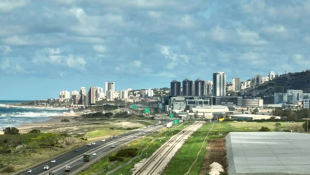 Southern entrance to Haifa in Israel north district, with city buildings and The Mediterranean Sea coastline