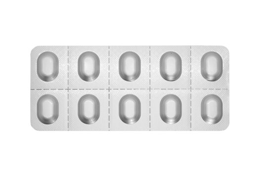 Macro shot pile of tablets pill in silver blister packaging isolated on white background. Aluminium foil blister pack. Pharmacy products. Medicine pills and drugs close up. Pills background