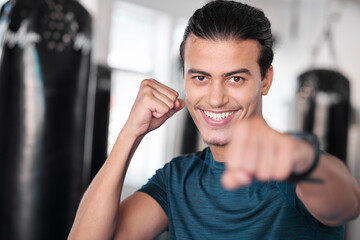 Portrait, boxer punch and smile of man in gym ready to start workout, training or exercise. Boxing sports, wellness face and happy male athlete throw fist for fight, exercising or mma for strength.