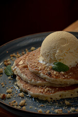 Delicious corn hot cake with vanilla ice cream on top and walnut.