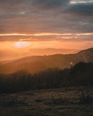 A beautiful sunset landscape with a sea view and mist over the cliffs