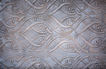 Gray background of decorative plaster with abstract spots. Unusual silver wall texture with beautiful patterns, creative surface background. Dressing coating for building cladding.