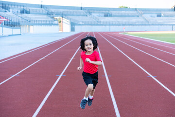 Fototapeta premium A girl athlete in training. Runner exercising. Jogging for kid.