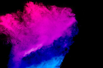Launched blue pink dust particles splashing.Bizarre forms of blue pink powder explosion cloud on white background.