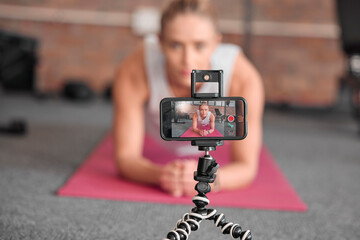 Live streaming, fitness and phone of woman exercise, pilates or workout on social media or video platform on tripod. Gen z athlete, sports influencer or content creator training on smartphone screen
