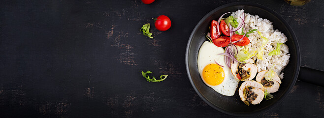 Fried egg, meat chicken roll, rice and tomatoes. Paleo breakfast. Top view, banner