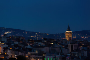 Defocused blurred panoramic view of Istanbul sityscape and galata tower during twilight time. Vibrant colors. Istanbul, Turkey (Turkiye). Cityscape background