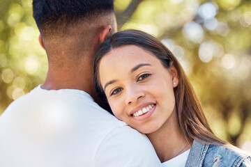 Obraz premium Love, hug and shoulder with couple in park for bonding, affectionate and free time. Happiness, date and smile with portrait of woman hugging man in nature for relax, summer and romance on vacation
