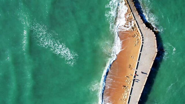 Top down aerial view of the street in the atlantic ocean that leads to the fortress of San Sebastian in Cadiz, Spain.