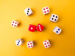 Top view Colored dice on a yellow background.