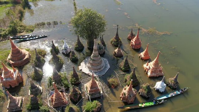 Sunlight reflection of  Stupas of Taw Mwe Khaung Pagoda in Shan State near Inle Lake, Myanmar - rare aerial footage