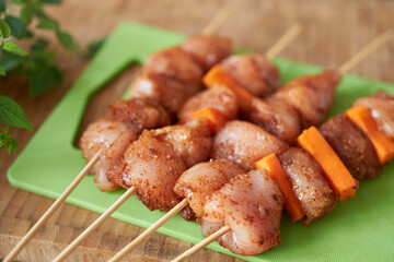 Chicken breast kebabs with vegetables on a green board, close-up. Diet Meat.