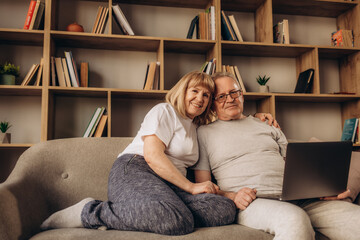 Senior couple using a laptop computer at home