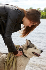 Owner girl travels with a husky dog. Friendship of a dog and a woman