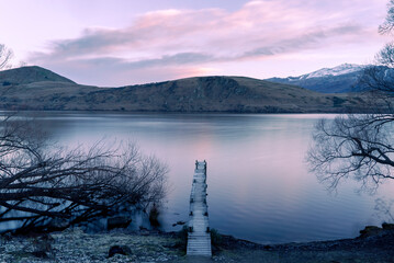 New Zealand landscape of a lake with a wharf near Queenstown