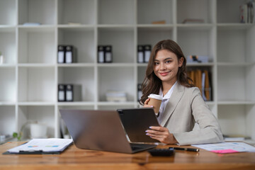 Portrait asian woman working with laptop in her office. business financial concept.
