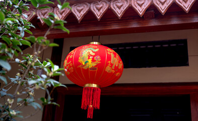 Red china lantern hanging on traditional roof during celebration new year. New year lunar 2023 symbol. Happy new year celebration 2023.