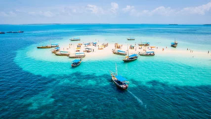 Foto op Plexiglas The natural beauty of Zanzibar's tropical coast is on full display in this aerial view, with fishing boats lining the sandy beach at sunrise. The top-down perspective showcases clear blue waters, © Sebastian