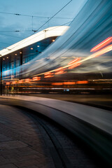 Fototapeta na wymiar fast moving tram at night in Augsburg