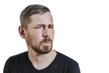 Fototapeta premium Portrait of an attractive bearded man of European appearance, with a slight gray hair, on an isolated white background. Wrinkles the nose. Expression of emotions of a man