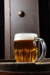 beer in a glass stands on a beer barrel in a restaurant
