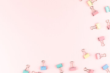 colorful binder clip on pink background
