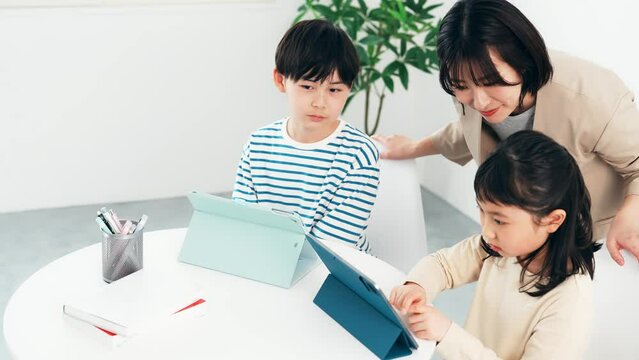 タブレットで勉強する子供たちと教える女性