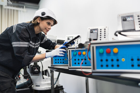 Engineer caucasian woman checking and repair electric machine in machine lap	