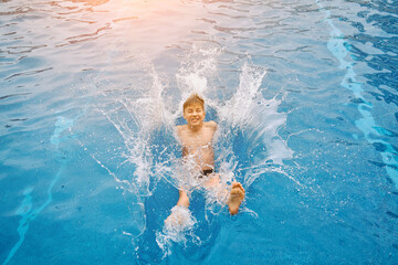 Child jump, swim in the pool, sunbathes, swimming in hot summer day. Relax, Travel, Holidays, Freedom concept.
