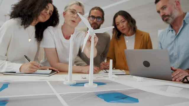 Business woman with industrial design expertise leading her team on a windmill project