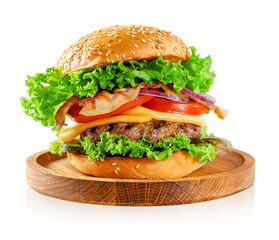 American food concept. Burger with beef and bacon on wooden plate on gray background.