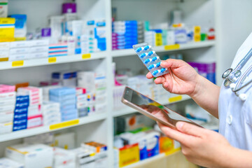 Pharmacist holding mobile phone using for filling prescription in pharmacy drugstore	