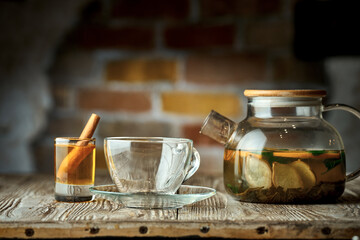 Fruit tea in a teapot. Composition with a cup, honey and teapot