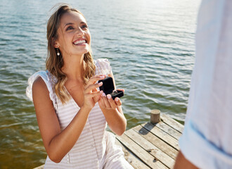 Happy, love and a woman proposing to a man, getting engaged and showing a ring. Couple, excited and...
