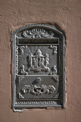An old letterbox in a house wall in Spain.