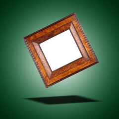 Fototapeta premium Floating Antique and vintage square frame in walnut wood on green gradient