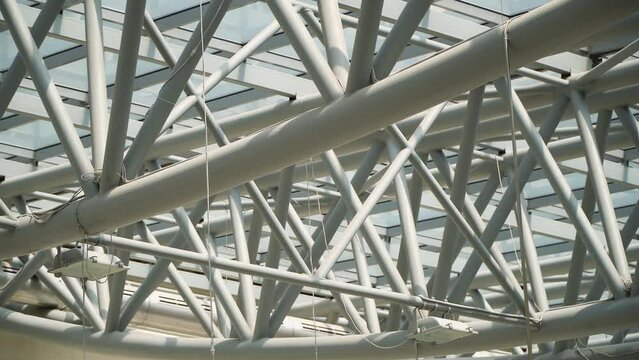 Roof of moden buildings. Abstract high-tech architecture background, internal metal frame structure of glass roof arch with lockable windows sections