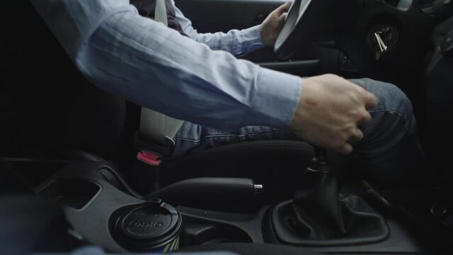 Car gear knob, a man's hand turns on the gear and starts driving. First transmission. A guy in a car. Close-up of the car's transmission. Go forward. Start movement. High quality 4k footage
