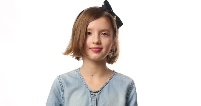 Teen girl child wearing jeans dress put hand on face facepalm in studio on white background, epic fail, amazed with stupid situation