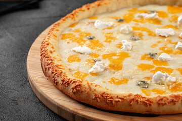 Closeup on four cheese pizza with cheddar and gorgonzola