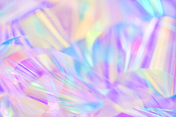 Blurred close-up of ethereal pastel neon blue, purple, lavender, yellow holographic metallic foil...