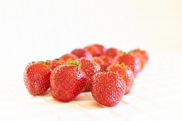 Bunch of ripe tasty red strawberries on white close up